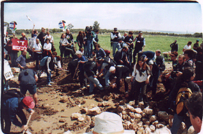 Peace activists try to move the hard earth - Photo   2001 by Rachel Avnery