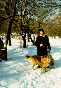 Di with Perry under blue sky in snowy Riverside Park - photo by Joan Nestle